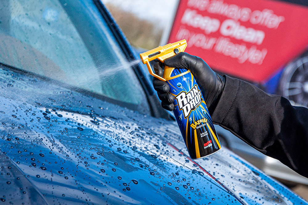 Photo of Soft99 Rain Drop car care product being sprayed on a car's bonnet.